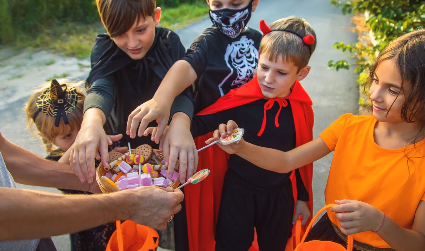 trick-or-teaters with candy on Halloween